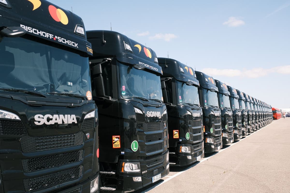 Fleet of black tractor units parked in a neat row outside a depot