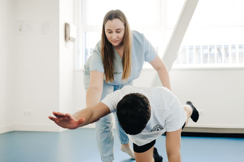 Physiotherapist working with a patient in a bright clinic